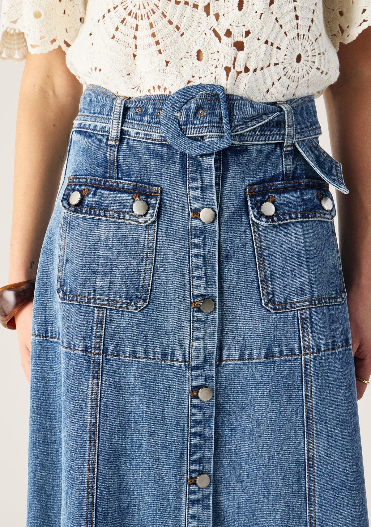 Mos the Label Aveline Denim Midi Skirt displayed on a model, featuring a fitted waist and a flared hem.