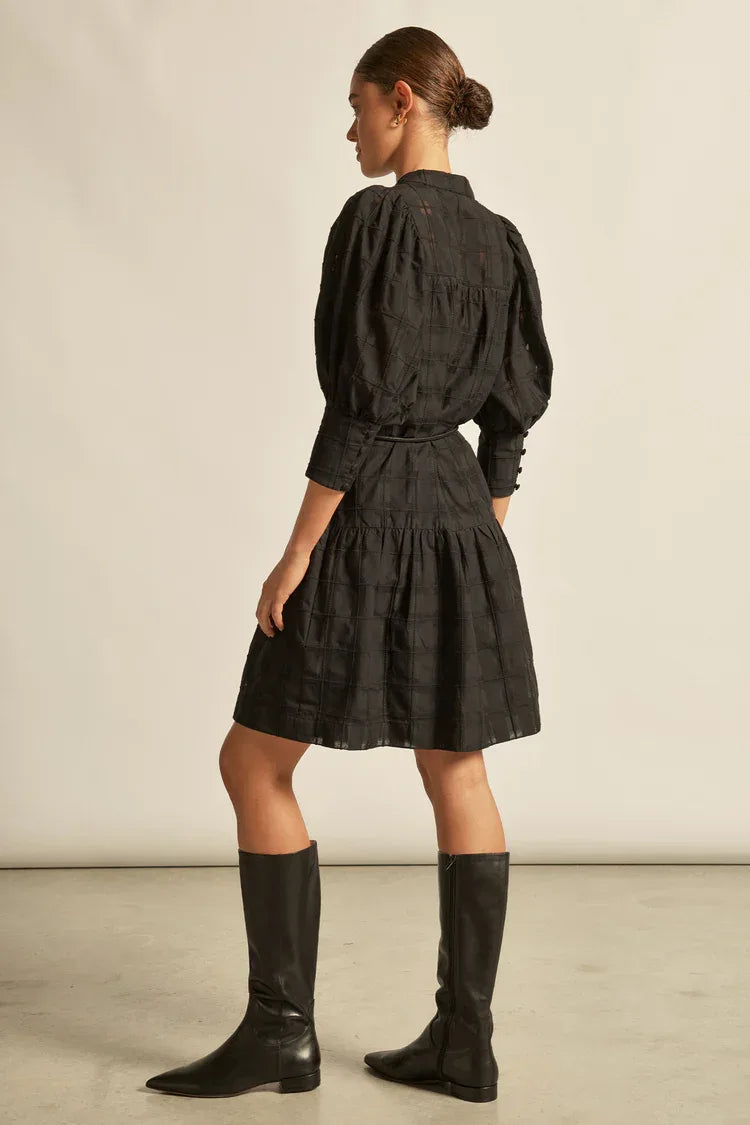 Zoe Kratzmann Paloma Dress in black check fabric, showcasing a stylish, contemporary design with a fitted silhouette and statement pattern.