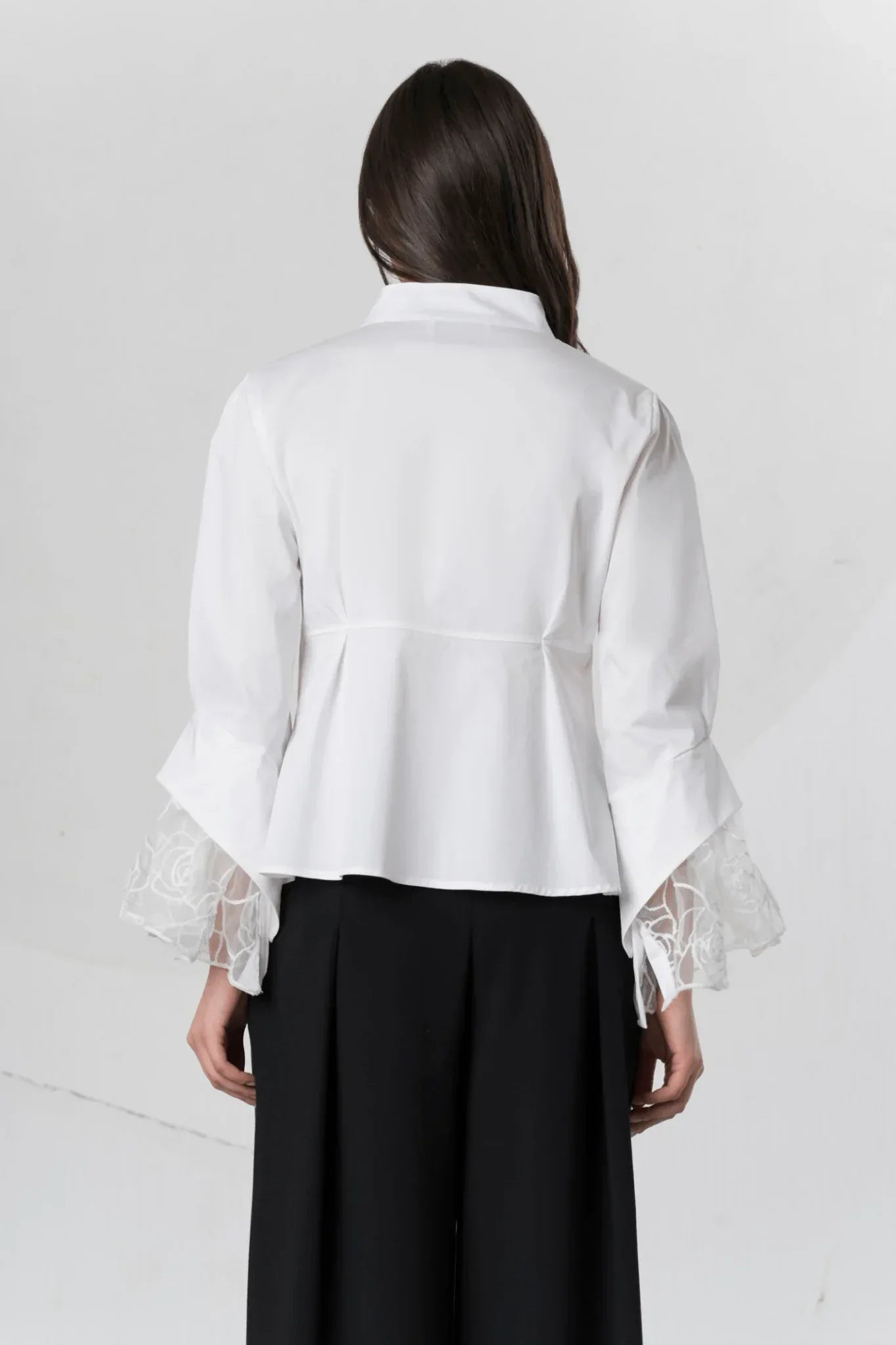 White Elisa Cavaletti blouse with lace cuffs, featuring elegant fabric and detailed lace accents on the sleeves.