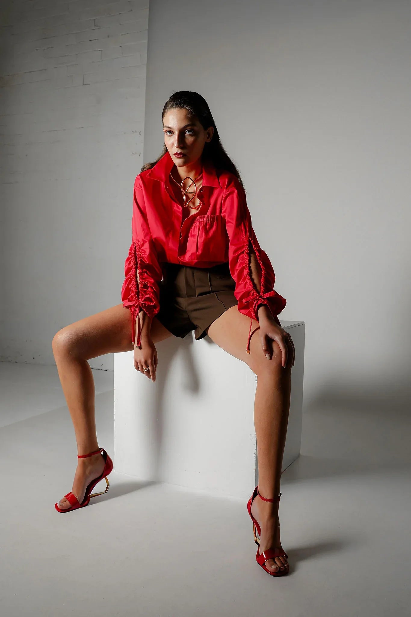 Realm Origin Edition Shirt in Rouge, featuring a stylish design, displayed on a flat surface with vibrant red fabric.