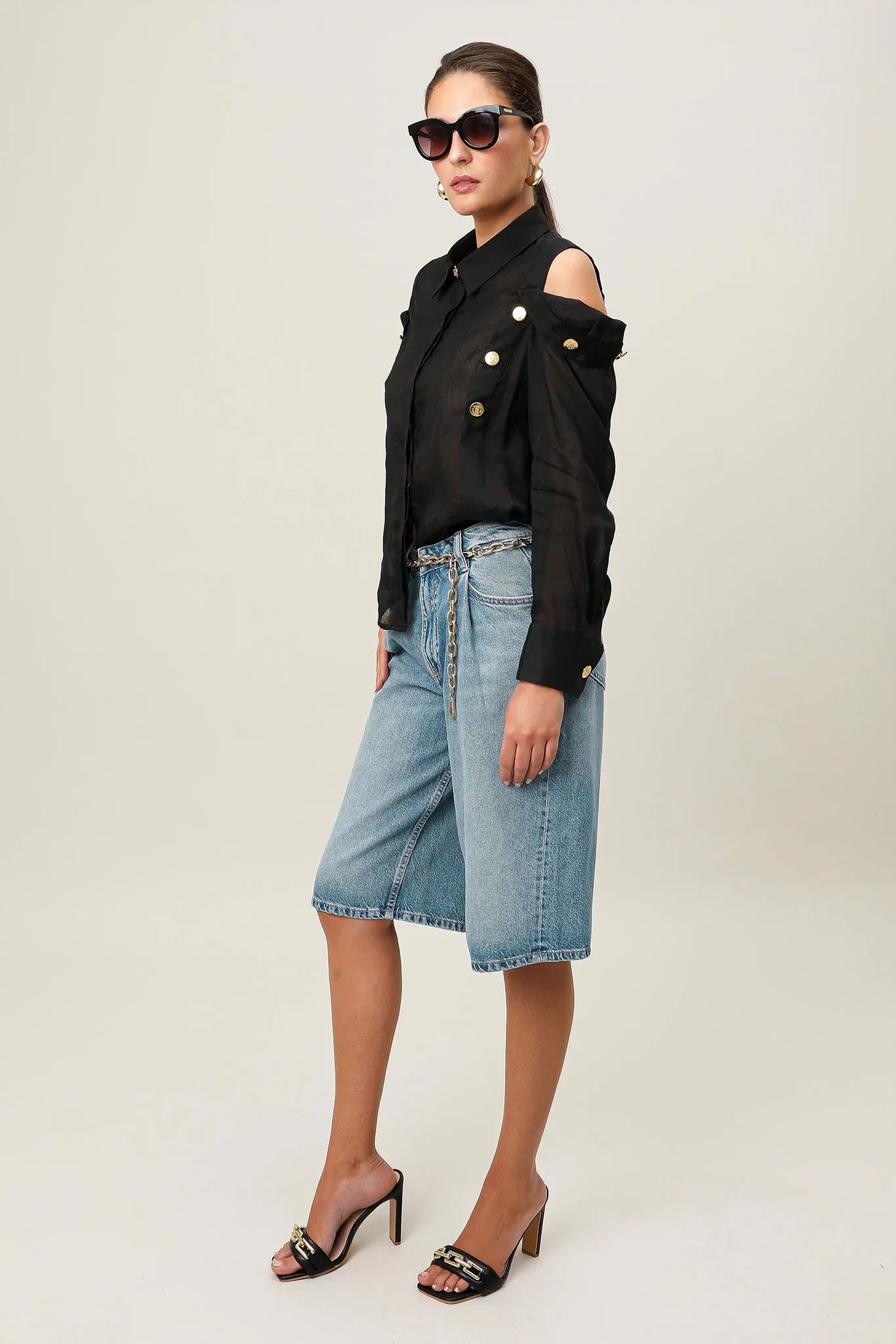 Black Realm Origin Vivre Shirt displayed on a hanger, showcasing its sleek design and modern style.