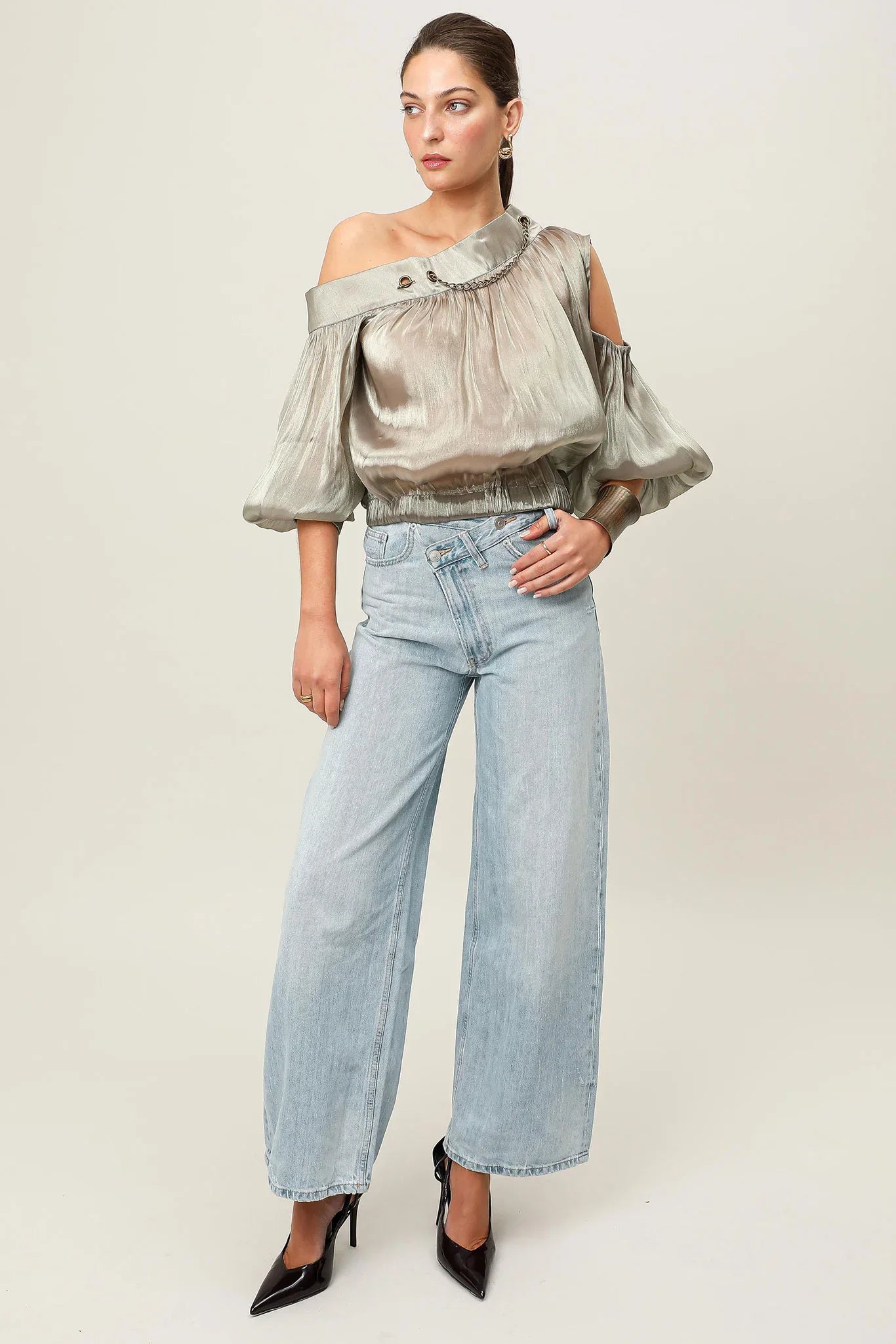 Metallic bronze Realm Origin Etoille Top with elegant design, showcased on a hanger against a neutral background.