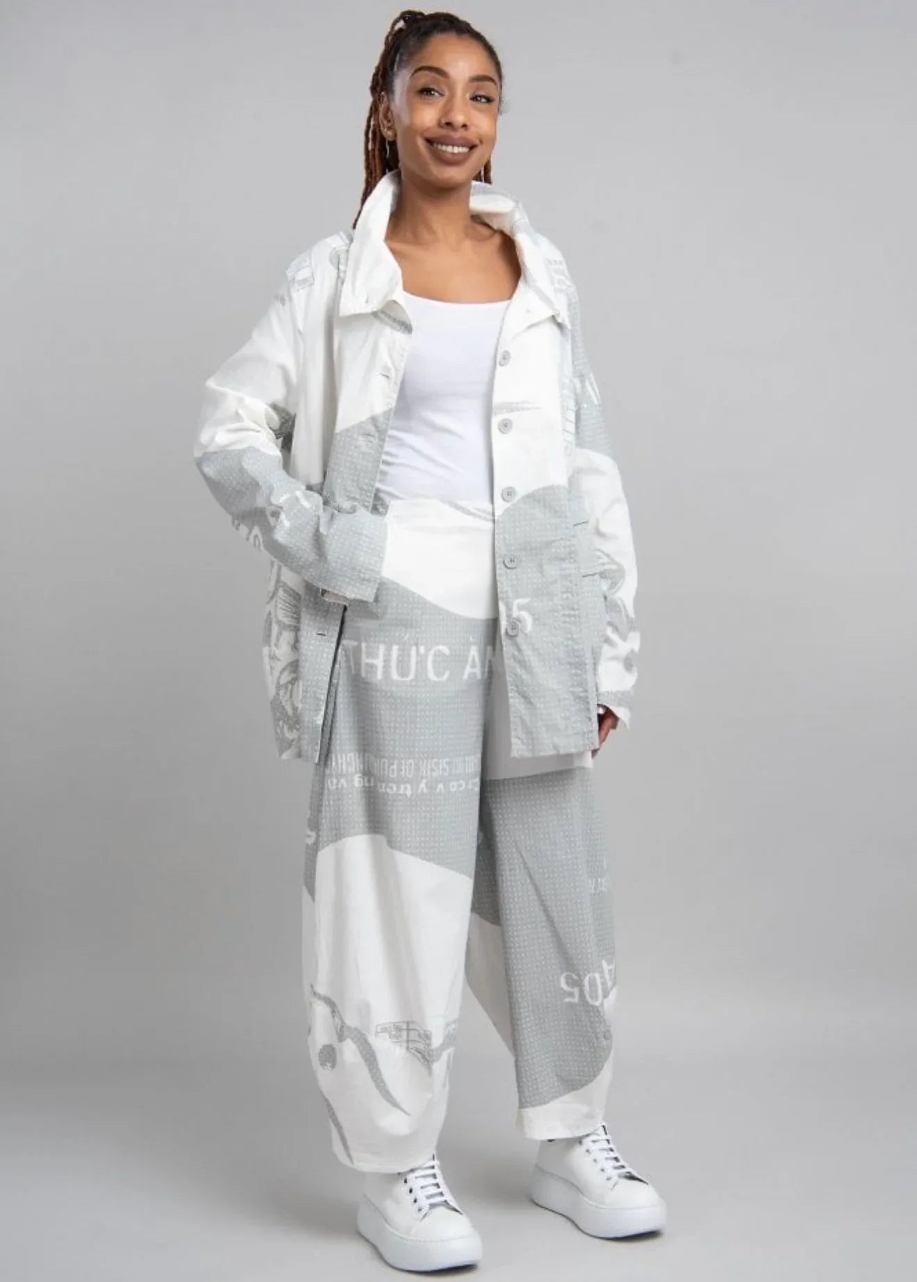 Rundholz barrel pants in white fabric with grey check pattern, showcasing relaxed fit and stylish design.