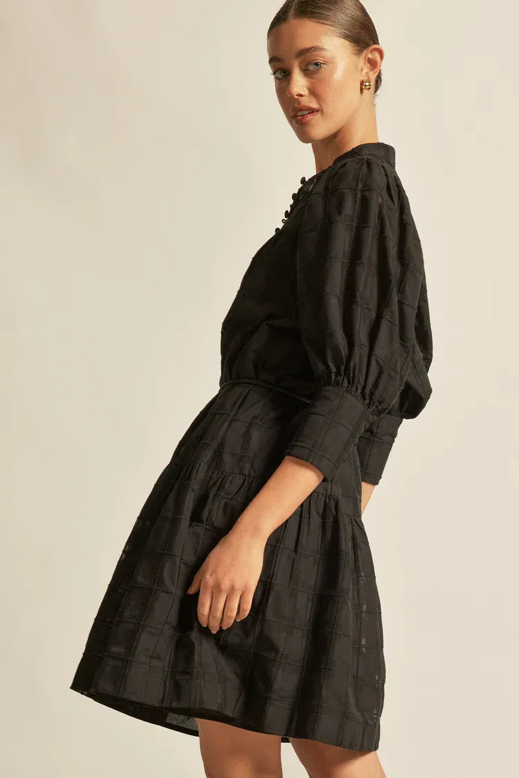 Zoe Kratzmann Paloma Dress in black check pattern, showcasing a stylish knee-length dress with long sleeves and a fitted silhouette.