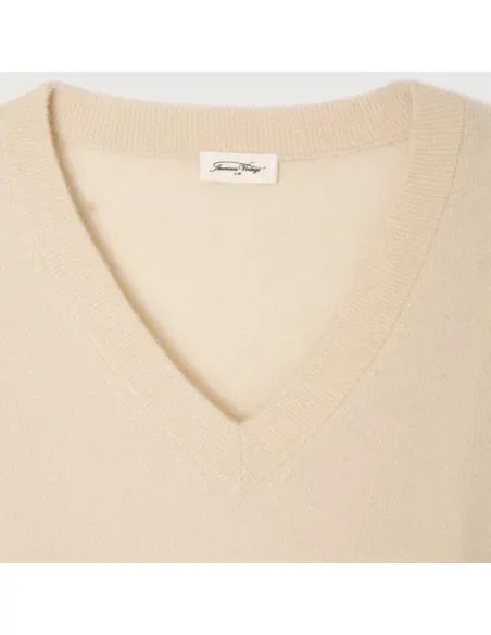 American Vintage Raxow V-neck sweater in natural color, soft knit fabric, displayed on a hanger with a neutral background.