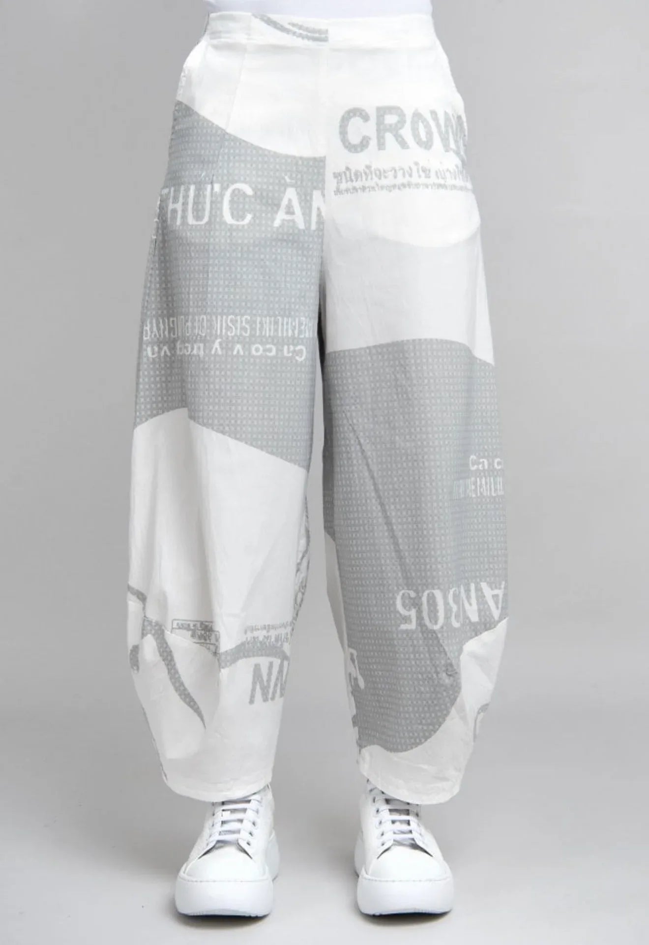 Rundholz barrel pants in white with grey check pattern, shown on a model, featuring a relaxed fit and stylish design.
