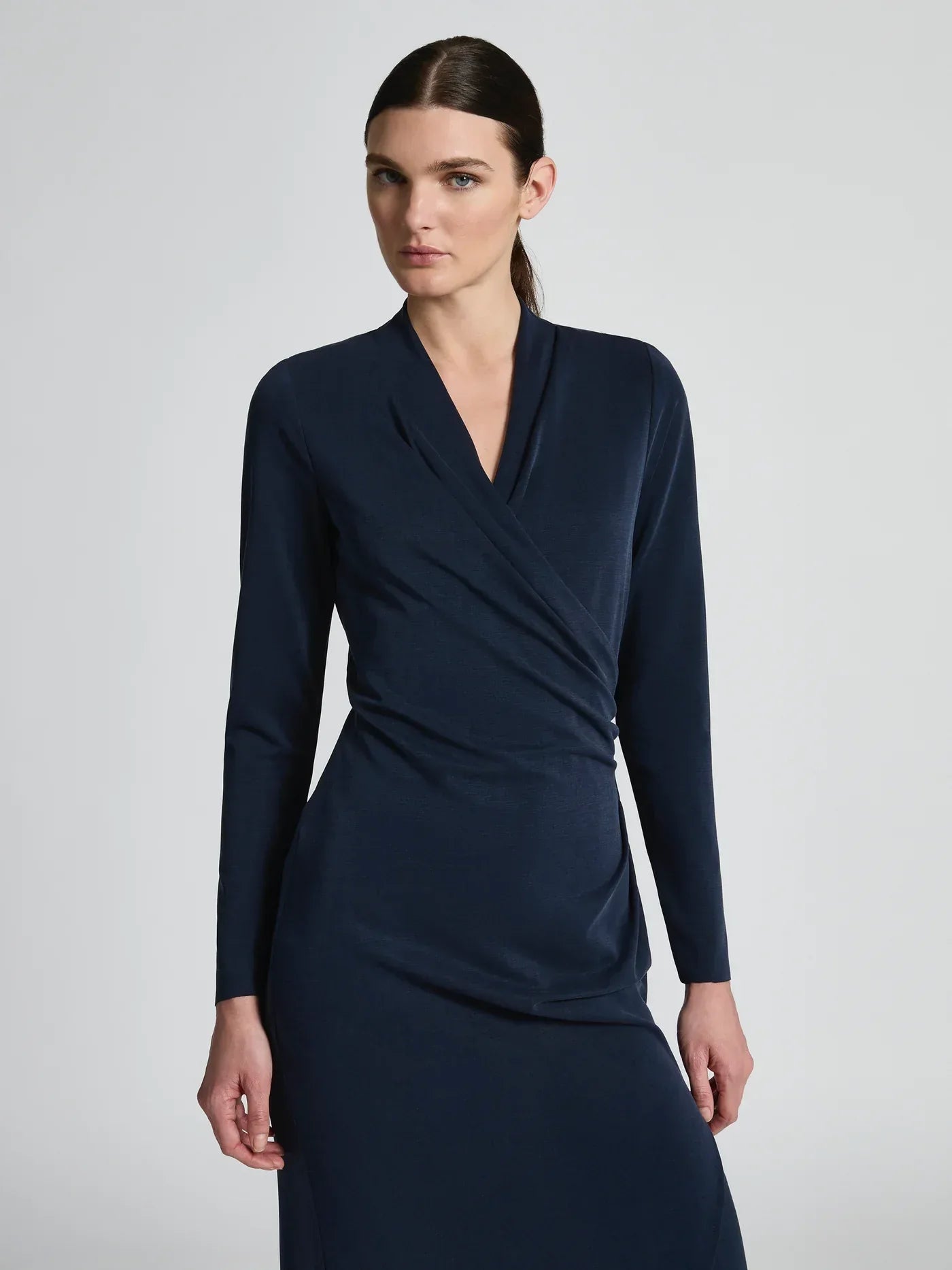 Navy Moss and Spy Jemma Dress displayed on a hanger, showcasing its stylish design and fabric details.