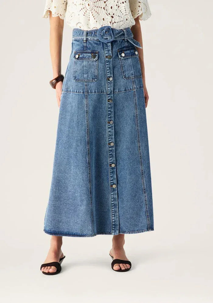 Aveline Denim Midi Skirt by Mos the Label, featuring a classic design and a flattering silhouette in a light wash.