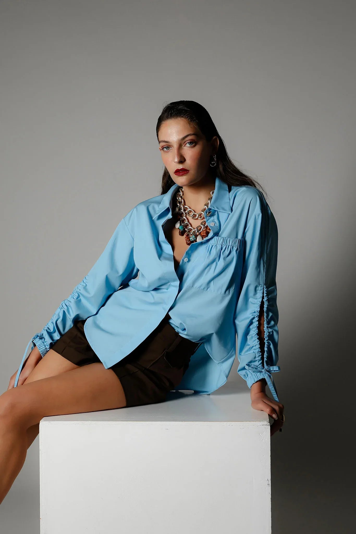 Realm Origin Edition Shirt in Azure, featuring a stylish design, displayed on a flat lay with visible fabric details.