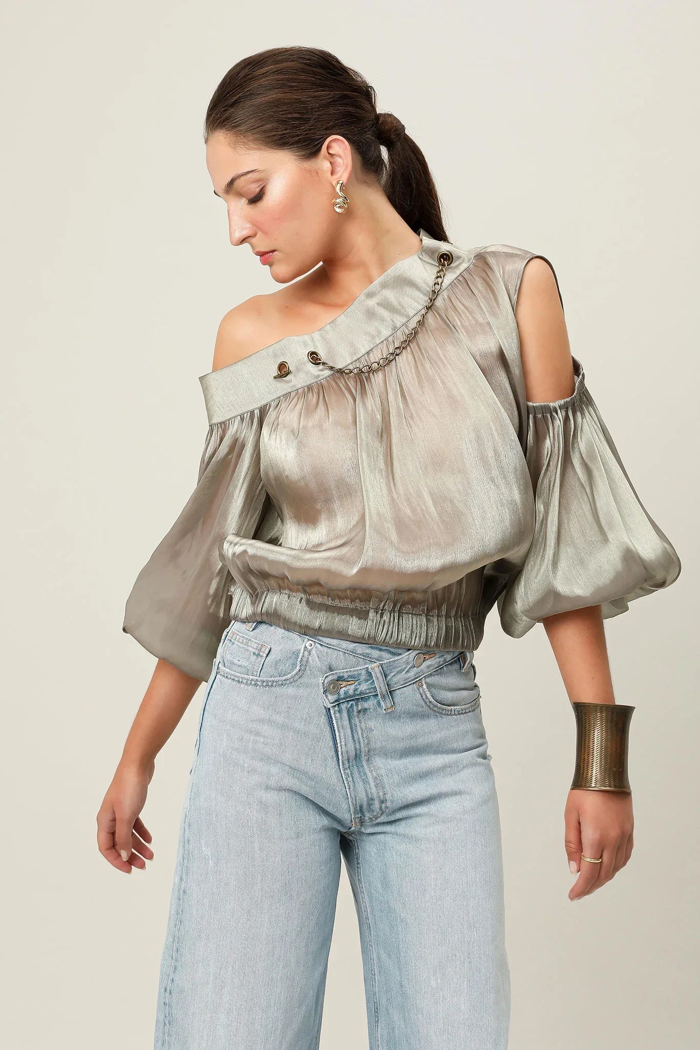 Realm Origin Etoile Top in metallic bronze, close-up of stylish, shiny fabric with a sleek, modern design.