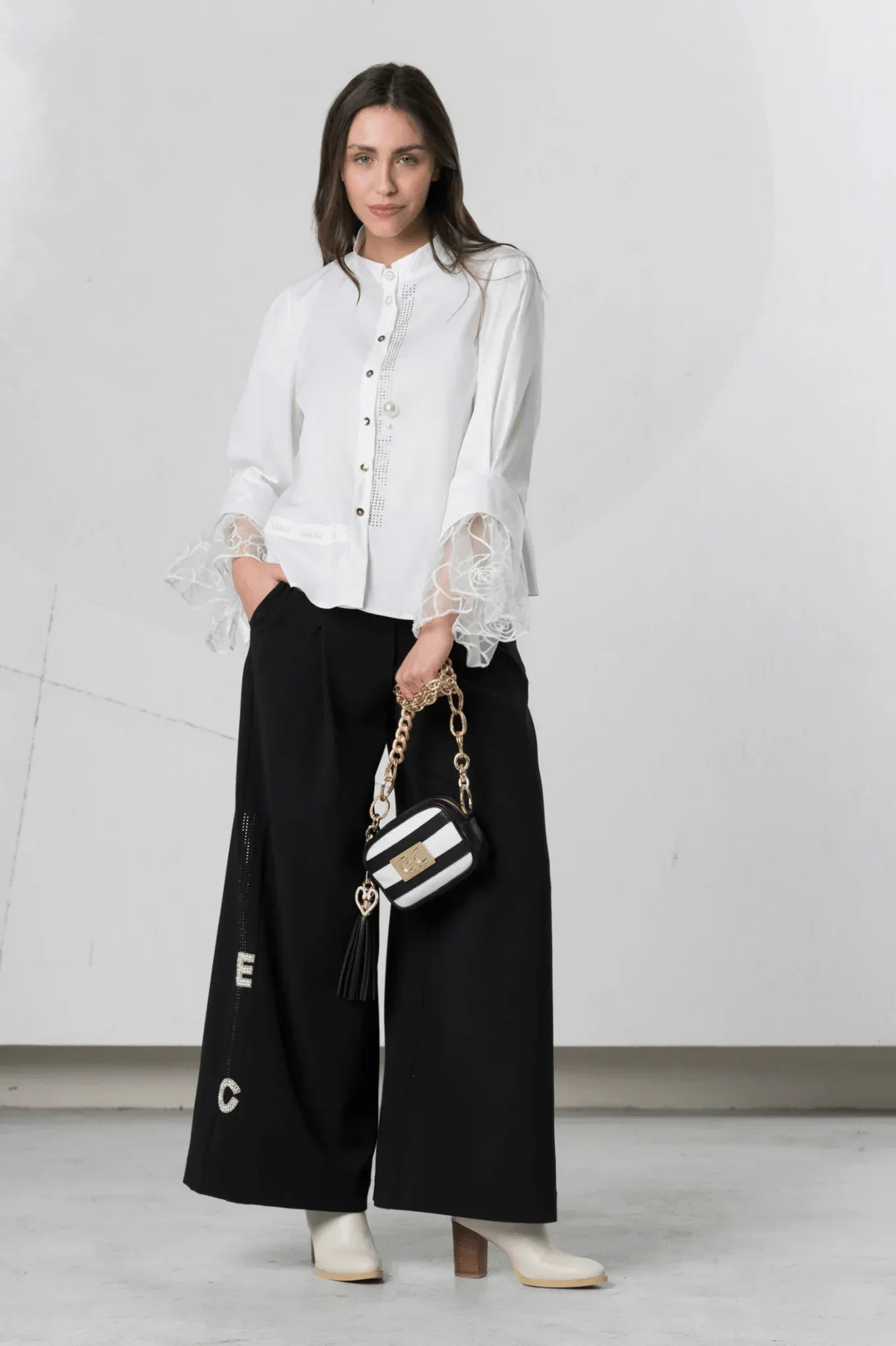 White Elisa Cavaletti blouse with lace cuff details and long sleeves, showcasing elegant, feminine design.