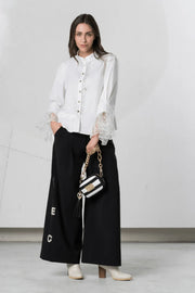 White Elisa Cavaletti blouse with lace cuff details and long sleeves, showcasing elegant, feminine design.
