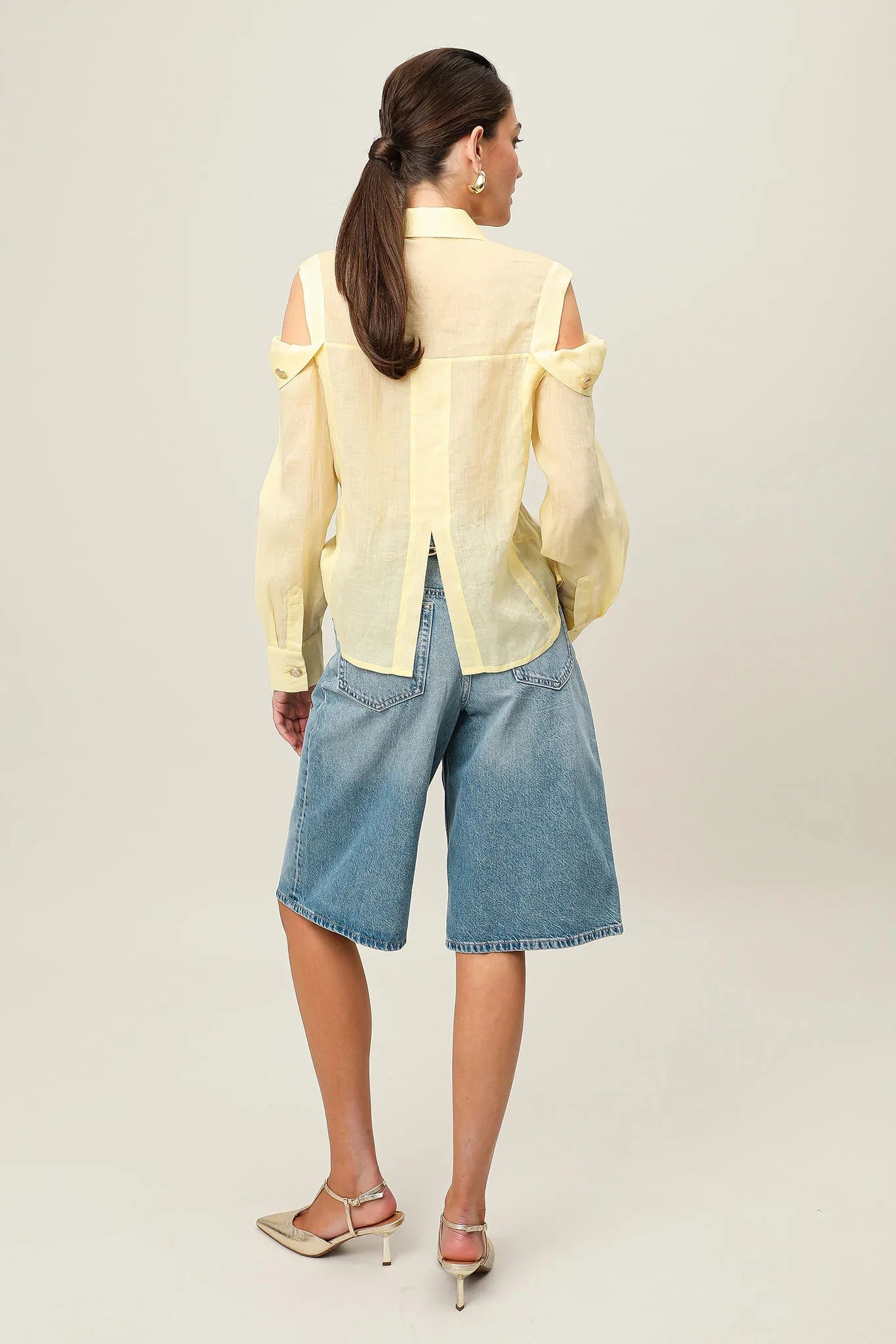 Yellow Realm Origin Vivre Shirt laid flat showcasing its collar and button details.