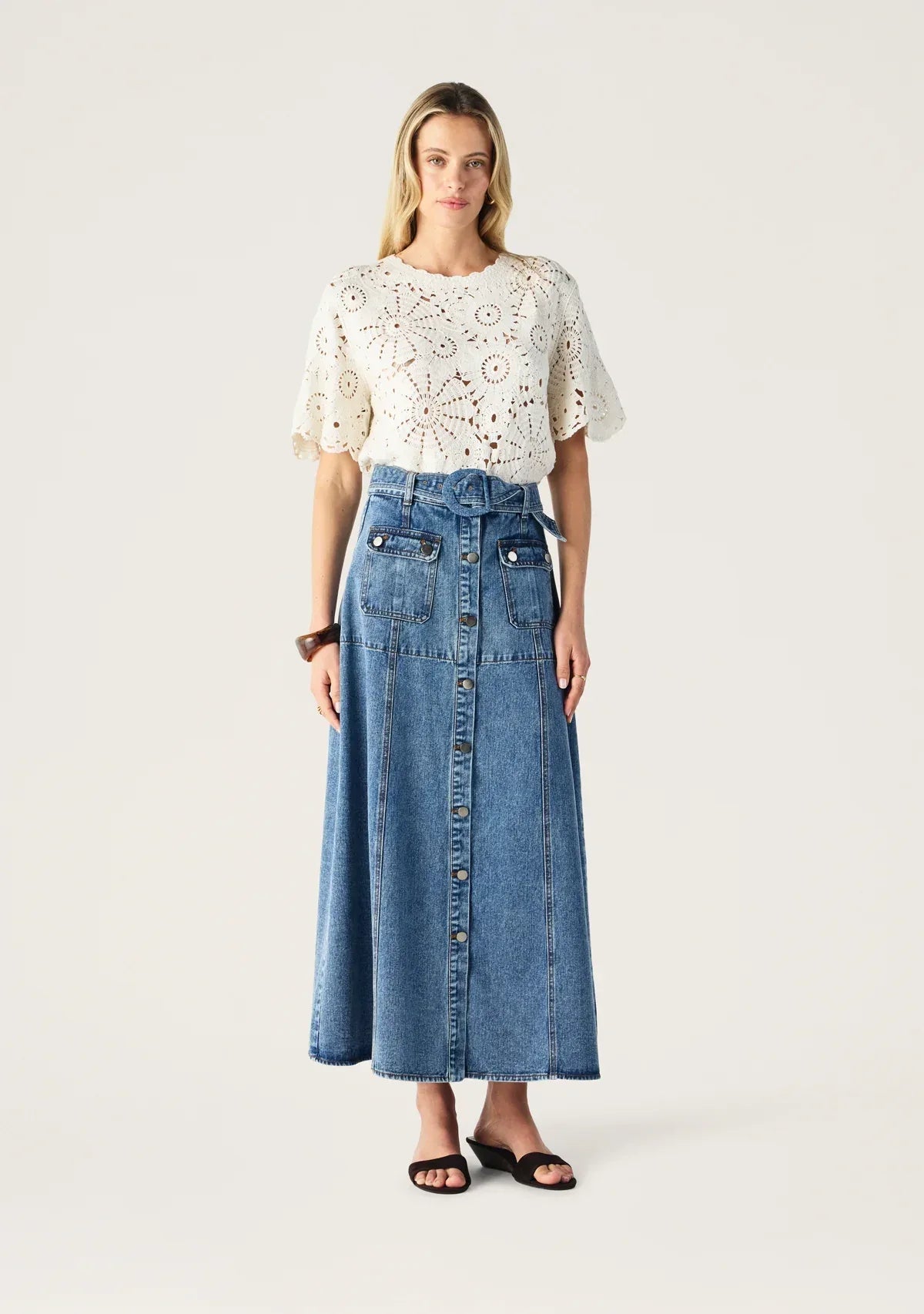 Aveline Denim Midi Skirt by Mos the Label, showcasing a classic blue denim design with a flattering silhouette.